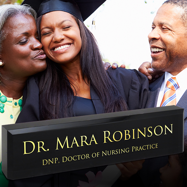 A family celebrating a graduation with a personalized acrylic desk block.